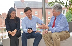 Dr. Ed Fisher (right) reviews a Peers for Progress app with student assistant Sarah Kowitt and program manager Patrick Yao Tang. (Photo by Linda Kastleman)