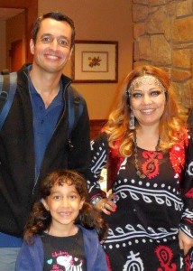 Dilshad (left) presents at a meeting of the Cary-Kildaire Rotary Club. He is accompanied by his wife (dressed in a Kurdish traditional costume) and their daughter. (Contributed photo)