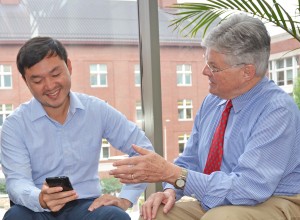 Dr. Edwin Fisher (R) speaks with Patrick Yao Tang, MPH, program manager of Peers for Progress.