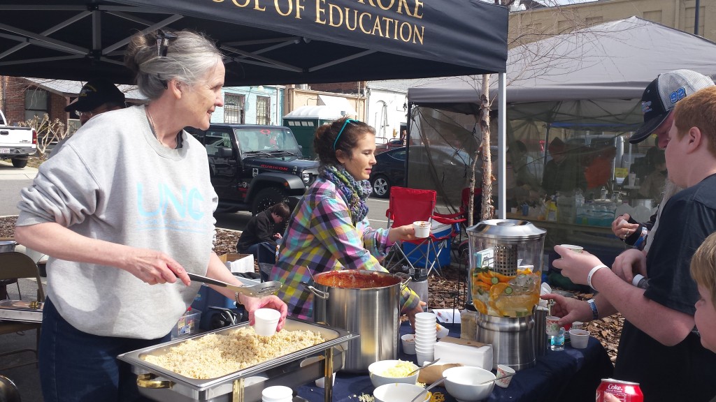 Dr. Ammerman (left) serves her Sweet Beat Rumba Chili at a chili cook-off in Robeson County in March 2016. (Photo by Catherine Rohweder)