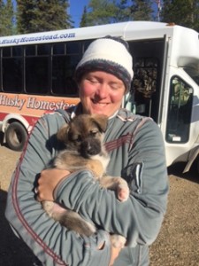 Mary cuddles a sled-dog-to-be while vacationing in Alaska. 