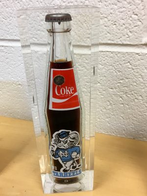 After winning a championship, UNC basketball players gifted Charletta's mom a commemorative Coke bottle as a thank-you for letting them use her beach house. These days, it stays in Charletta's office. 