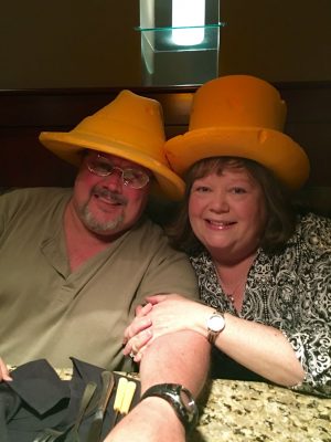 Angie smiles with her husband, Jon. In her words: "We were at the Melting Pot having fondue, so of course we had to be cheeseheads!" (Contributed photo)