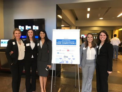 Aditi Borde (in the skirt suit) and Chelsea Anderson (in the light grey suit) represent the Gillings School on their interdisciplinary team. (Contributed photo)