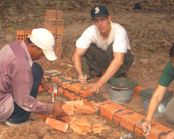 Reed Palmer (right) butters bricks in Panama.