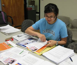 Sue Naorungroj, epidemiology master's student, prepares materials about H1N1 flu.
