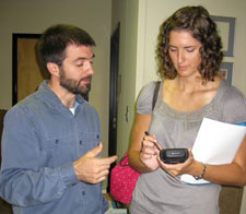 Matt Simon, NCCPHP staff member, instructs a Team Epi-Aid volunteer in the use of a handheld computer for collecting survey data.