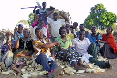 Alu (center) poses with village leaders in Malawi.