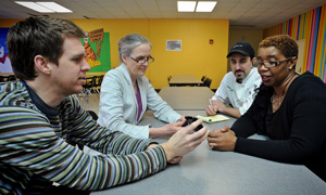 David Cavallo, left, and Alice Ammerman, second from left, meet at Chapel Hill High School with chef-trainer Ryan McGuire and kitchen manager Geneva Long to discuss the pilot project Taste Texting, which allows students to pre-order healthy school meals using their cell phones.