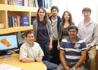Dr. Marc Serre (seated, left) consults about a disease-mapping project with fellow researchers (l-r) Jeannette Reyes, doctoral student; Dr. Yasuyuki Akita, postdoctoral fellow; Lani Clough, master's student; and Prahlad Jat (foreground) and Kyle Messier, doctoral students. All work or study in the environmental sciences and engineering department.