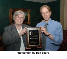 Photograph, DuBose receives award from Rob Kramer, director of T&D