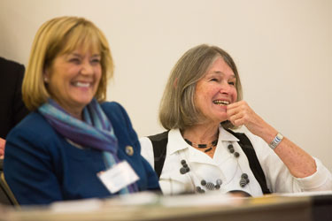 Dr. Jo Anne Earp (right) enjoys hearing stories told by a symposium speaker. On the left is current health behavior chair, Dr. Leslie Lytle.