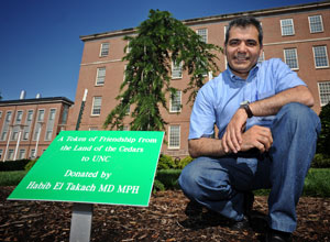 Dr. Habib El Takach is shown here with the Lebanon cedar he presented to the School. Photo by Dan Sears.