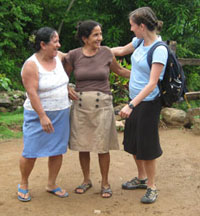 Garrett, right, stops for a conversation with two women in Honduras.