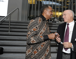 Dr. Mike Cohen (right) greets UNAIDS executive director Michel Sidibé outside the World Bank in New York City.