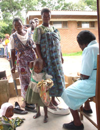 Malawian women and their children wait in a line for clinic services in 2005. Photo by Steve Meshnick, MD, PhD, professor of epidemiology.