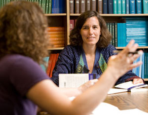 Dr. Suzanne Maman, associate professor of health behavior and health education, listens to a student's presentation.