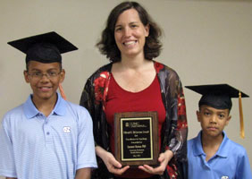 Dr. Suzanne Maman celebrates her McGavran award with sons Emile (left) and Miles.