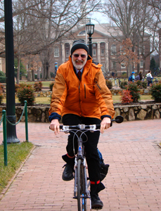 Dr. Barry Popkin takes personally his professional campaign for good health, regularly biking to campus for exercise. (Note: Popkin removed his helmet to pose for this photo, but he never bikes without it.)
