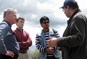 Don Lauria, PhD, retired professor of environmental sciences and engineering and EWB adviser, and Ryan Kingsbury, master's student and UNC EWB president, talk with members of Ecuadorian nonprofit Fundacion Natura about the problems that the communities of El Inga Bajo and El Inga Alto are having with their water system.