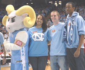 UNC students Rahel Gebremeskel, Gregory Allison and Kendall Lancaster joined the Carolina mascot, Rameses, on the court during halftime at the Feb. 13 Carolina-N.C. State game to show support for H1N1 immunization. Photo courtesy N.C. Division of Public Health.