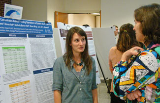 Jen Shields (left) discusses her research with Dr. Anna Schenck, associate dean for public health practice.
