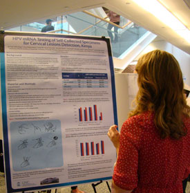Christin Daniels, director of research at the School, studies Jie Ting's winning poster.