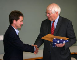 Searing receives a U.S. flag from Rep. Price.