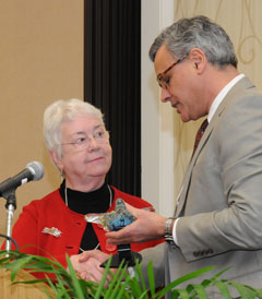 Dr. Rachel Stevens accepts the Levine Legacy Award from N.C. State Health Director Dr. Jeffrey P. Engel.