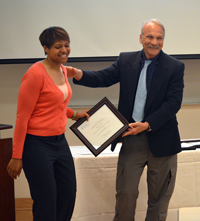 Alicia Stokes receives her award from Director of the Executive Master's Program, Jim Porto, PhD