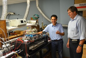 Drs. Will Vizuete (left) and Ken Sexton describe the workings of Quantaire, a portable air-sampling device they developed.