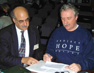Dr. William Zelman (left) works with a Project Hope participant in Poland in the 1980s.