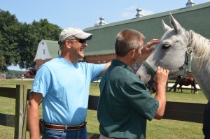 Gentry (left) and Dr. Jimmy Tickle admire a horse corralled at NCSU's College of Veterinary Medicine. (Photo by Linda Kastleman)
