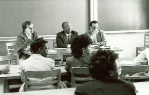 Dr. Richard Andrews (left) professor of environmental sciences and engineering, was a panelist at a Minority Health Conference in the 1980s.