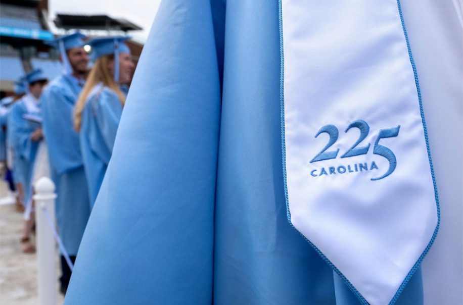 A blue gown shines on commencement day.