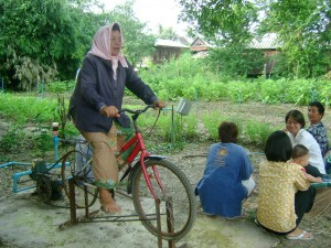 In Thailand, village health volunteers helped residents establish a community garden. The bicycle, connected to a generator and water pump, irrigates the garden and provides a source of exercise. (Photo provided by Dr. Ed Fisher)