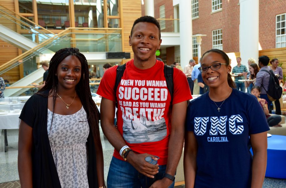 Students pose together after an event in the Atrium.