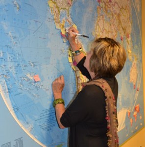 Dr. Peggy Bentley, associate dean for global health at the Gillings School, marks on the map one of the many countries in which she has conducted research.