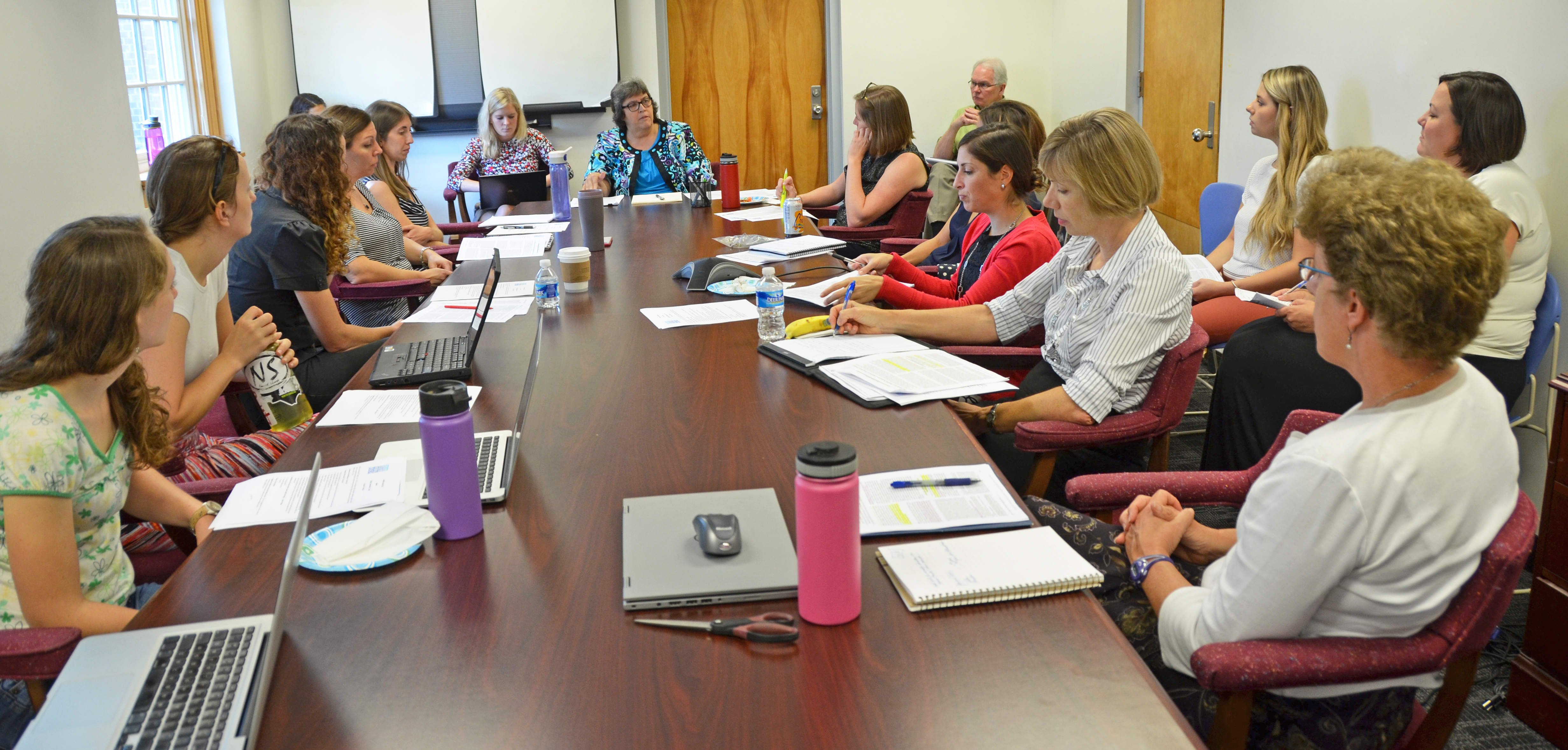 Members of the Carolina Collaborative for Research on Work and Health (CCRWH) meets in a conference room in Rosenau Hall.