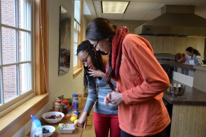 Two students confer over a healthy recipe during a nutrition class.