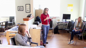 Holliday, at center, describes to her students some of the challenges related to older adults’ taking in sufficient nutrients. (Images from video by Mary Lide Parker)