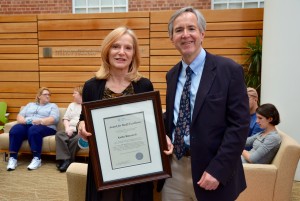 Kathy Biancardi (left) accepts the Gillings School's Staff Excellence Award from Dr. Herbert Peterson. (Photo by Jennie Saia)