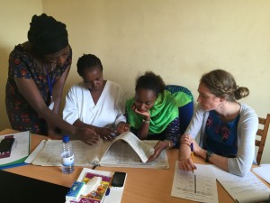 Leigh Tally (right) reviews information with staff members at Murara Health Center, in Rwanda. (Photo by Sara Forhan)