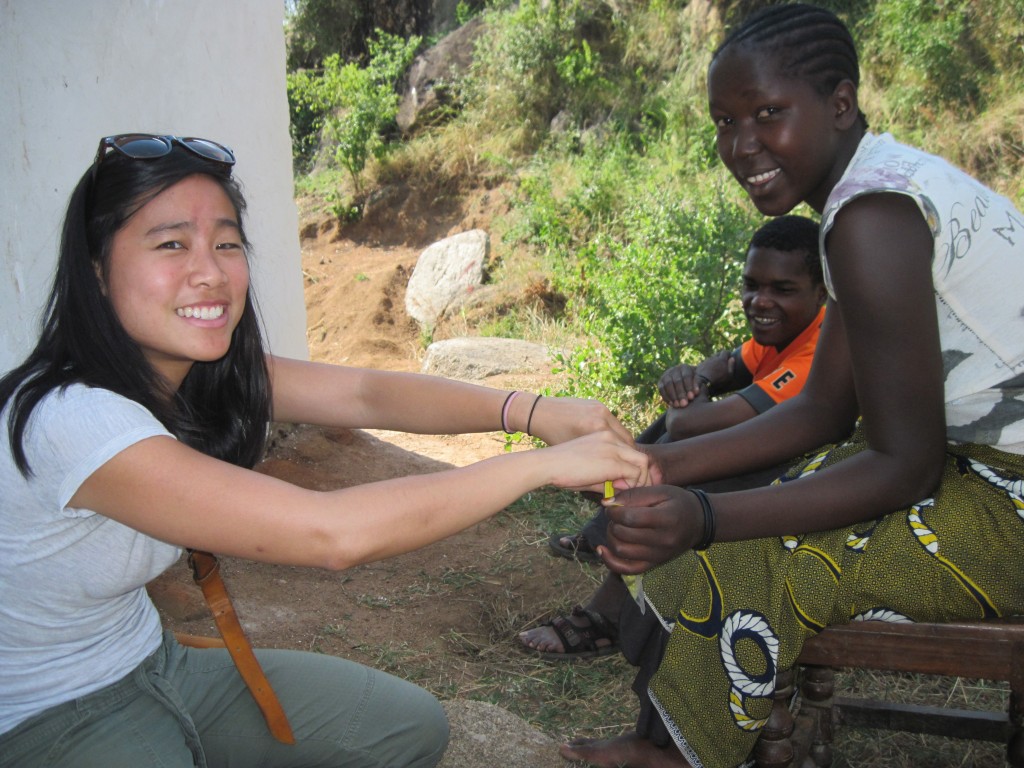 Dr. Alice Wang (left) shows a young woman in Mwanza, Tanzania, how to use a portable test for drinking water quality. (Contributed photo)