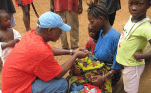 Dr. Saye Baawo administers a medication to a child in Liberia.
