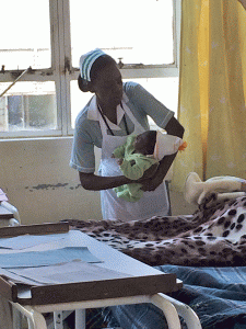 A midwife holds a newborn iat University Teaching Hospital in Lusaka, Zambia