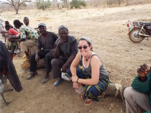 Charlotte Lane (right), nutrition doctoral student, sits with residents of a village in Burkina Faso.
