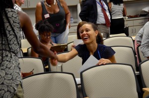 A student greets a new classmate during orientation.