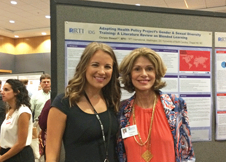 Christin Stewart (left) poses with Dr. Leah Devlin in front of Stewart's research poster.
