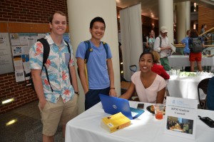 Three health policy and management student catch up during the Gillings School's annual Student Organizations Activity Fair.